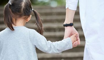 Young child holding an adult's hand